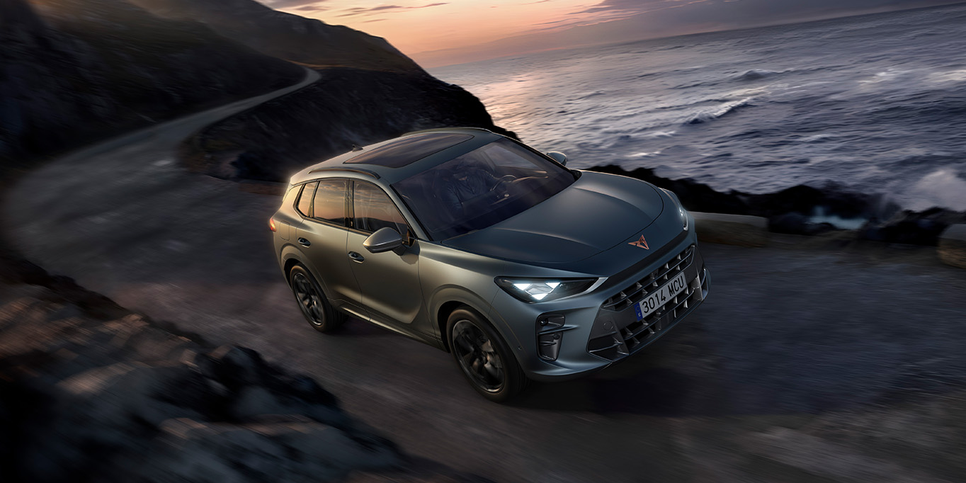 the new cupra terramar 2024 hybrid suv on a wet pavement by the sea, featuring sleek headlights, modern alloy wheels, and a shark-inspired front design