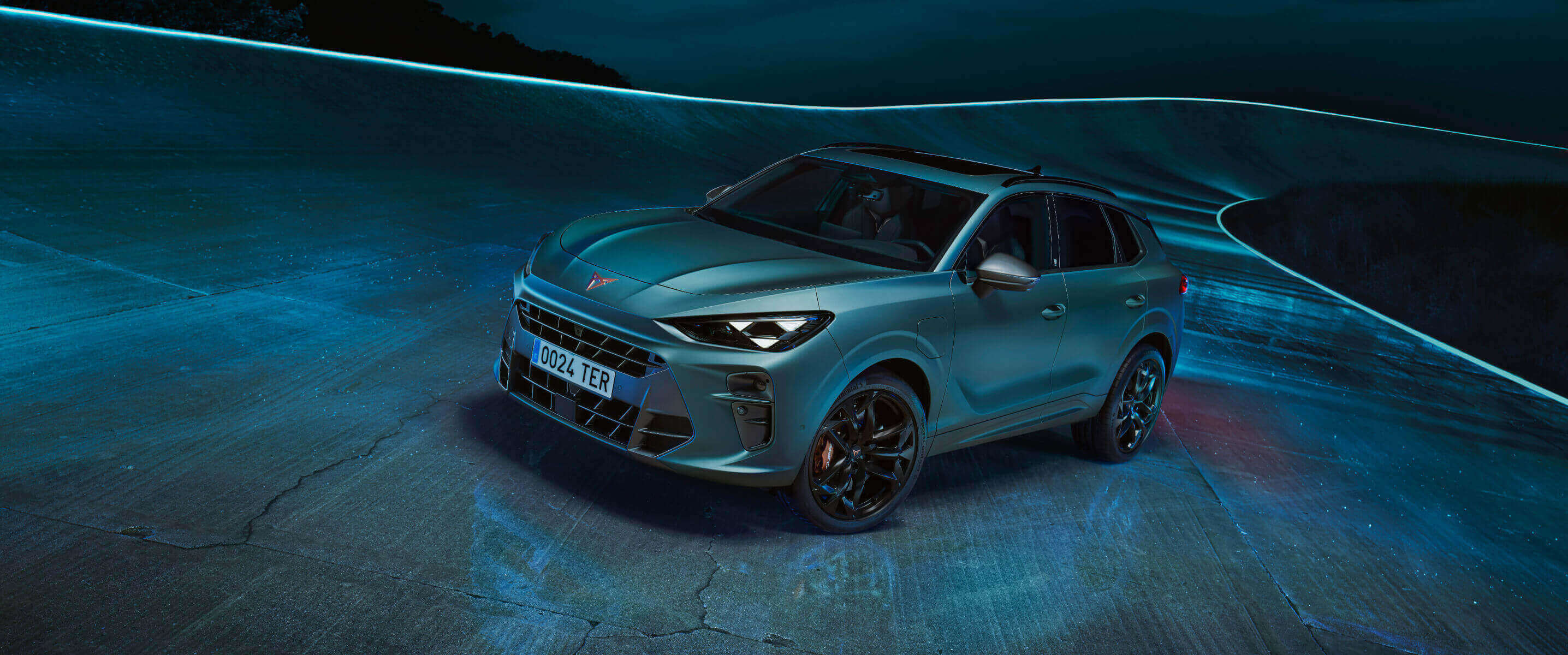 The CUPRA Terramar, a compact SUV design and one of the seven finalists for the car of the year 2025 event at the brussels international motor show, displayed under blue lighting.