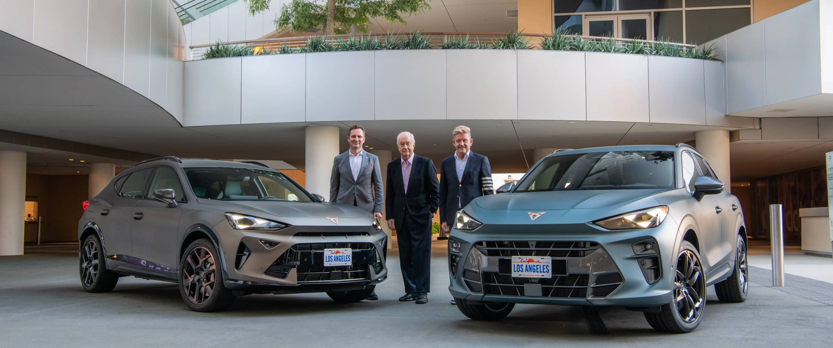 Ceo of cupra, wayne griffiths,  roger penske and thomas schäfer in front of the cupra terramar and formentor, making plans for cupra's us launch by 2030.