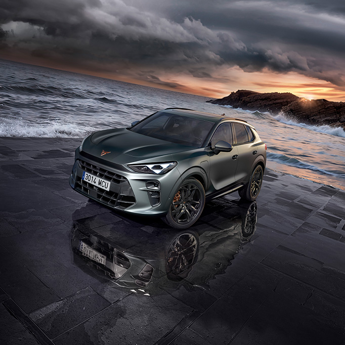 the new cupra terramar 2024 hybrid suv on a wet pavement by the sea, featuring sleek headlights, modern alloy wheels, and a shark-inspired front design