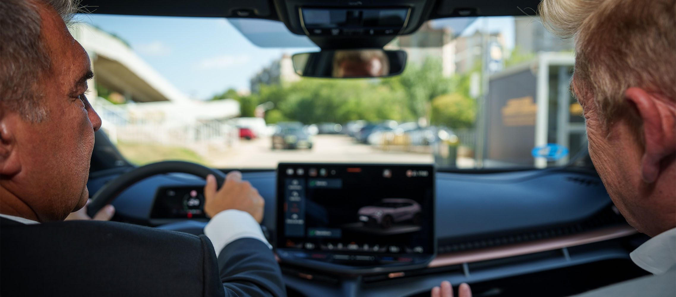 joan laporta and wayne griffiths inside cupra tavascan with infotainment system