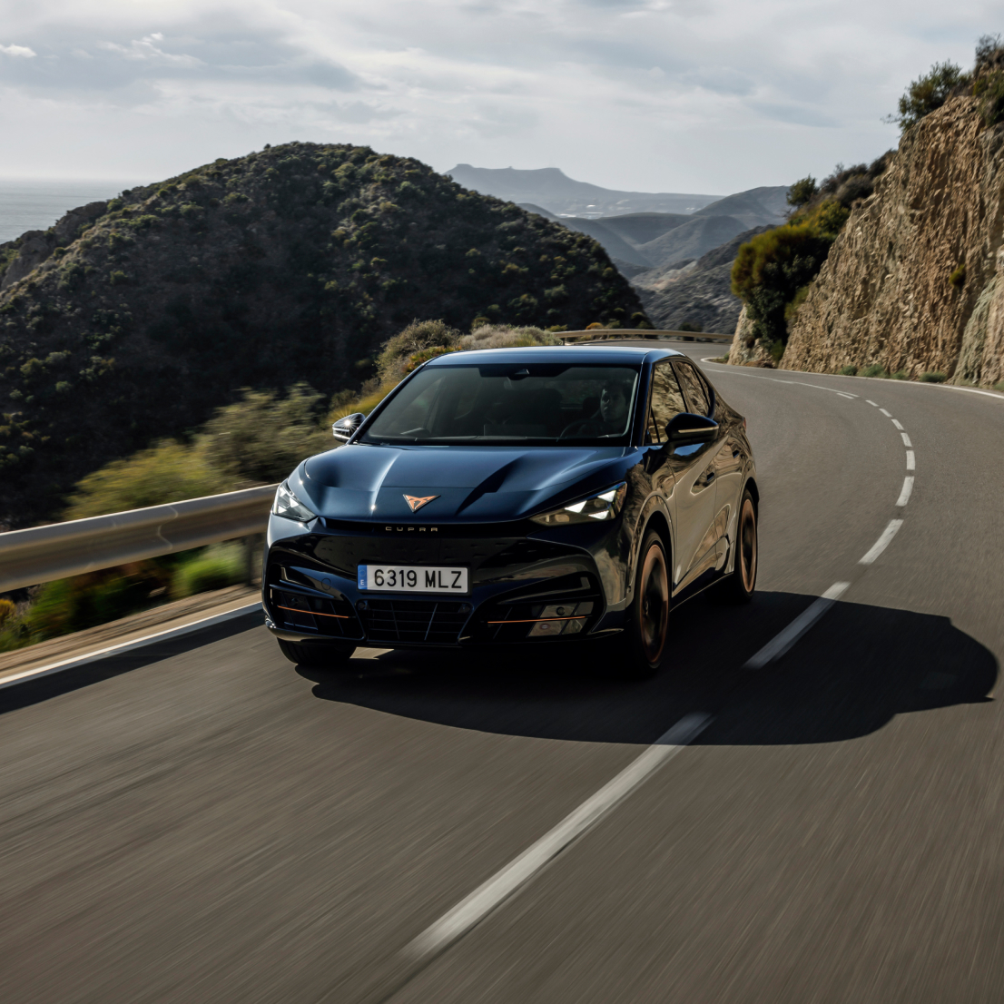 electric suv, cupra tavascan car on a coastal road and a five star euro ncap safety rating