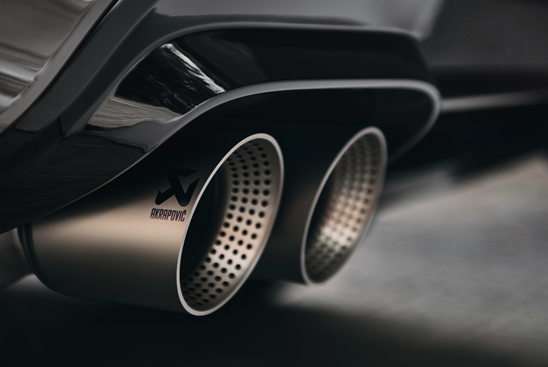 Close-up of the CUPRA Ateca's high-performance Akrapovič double twin exhaust system, enhancing performance and sound.