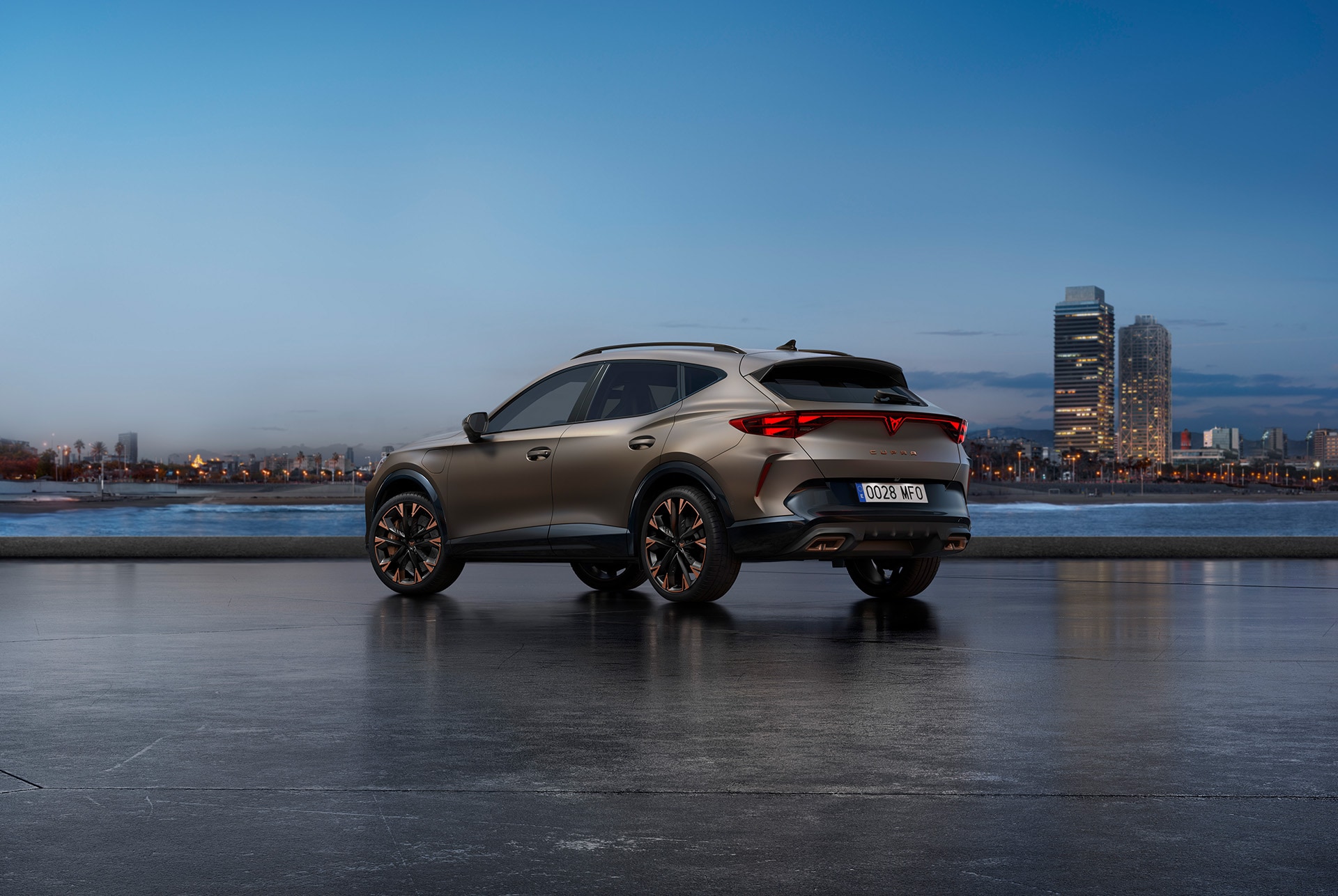 The new Cupra Formentor parked surrounded by a futuristic architecture and the city's skyline, showcasing its angled, rear design and lights.