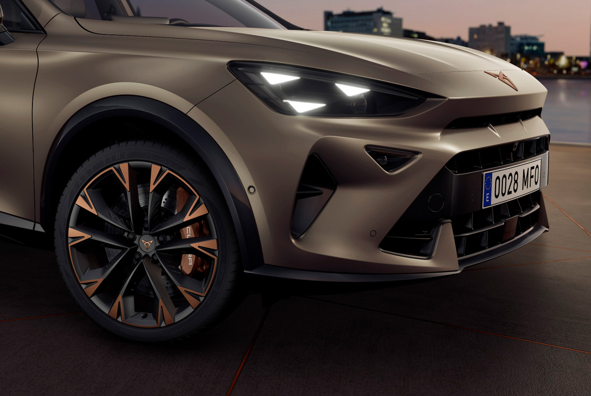 Exterior view of new CUPRA Formentor 2024 copper accent wheels, Akebono brakes, wing mirror, tyres, signature triangle eye LED headlights and CUPRA logo.