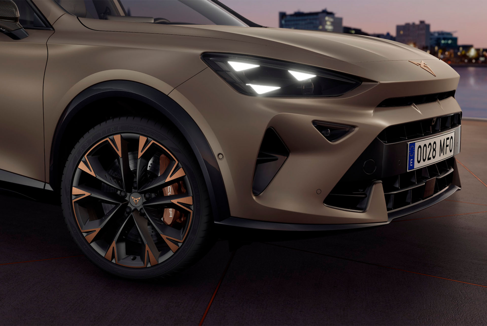 Exterior view of new CUPRA Formentor 2024 copper accent wheels, Akebono brakes, wing mirror, tyres, signature triangle eye LED headlights and CUPRA logo.