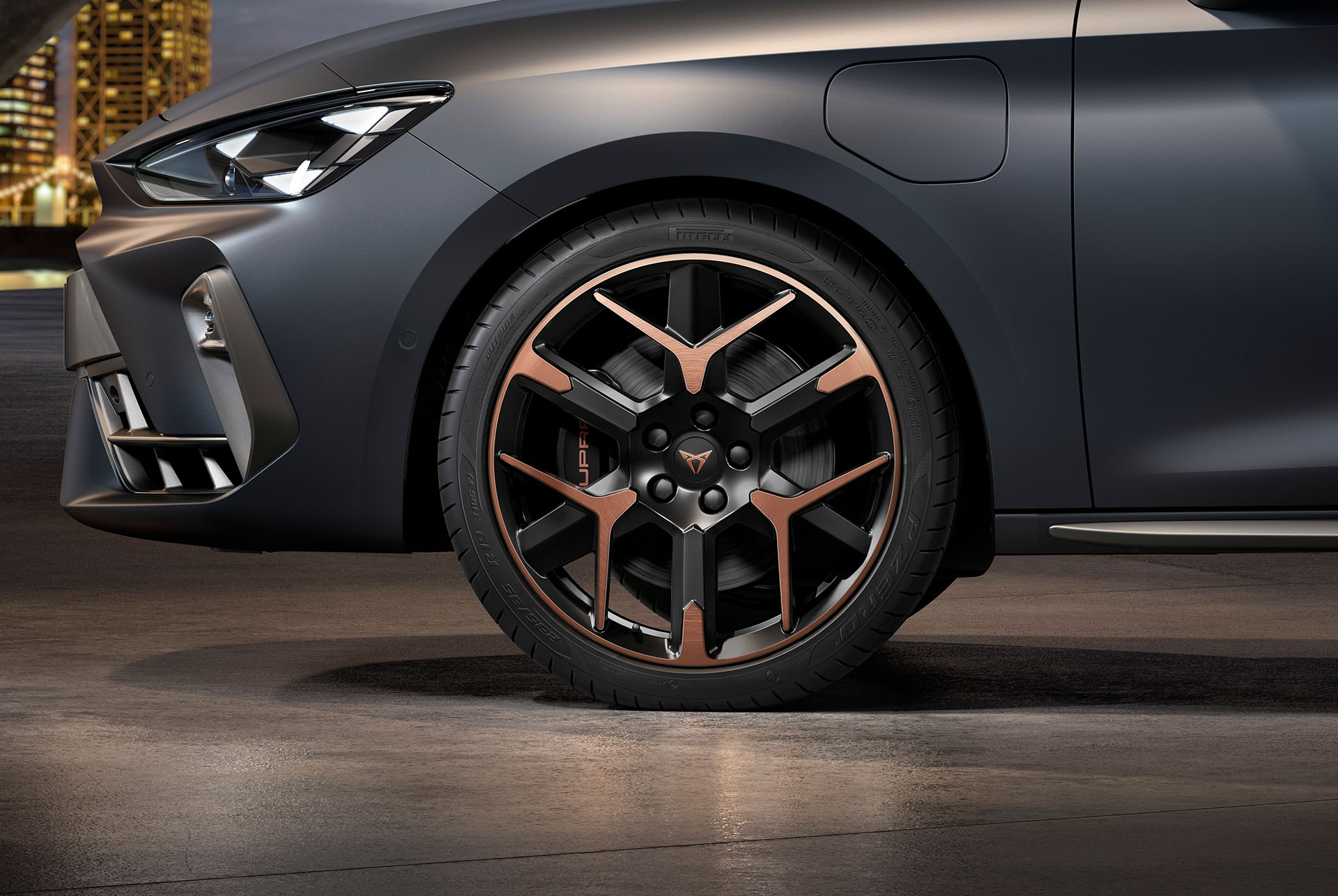 front side view of left forged alloy wheel in copper and black for the new cupra leon spotstourer 2024, tyres, signature headlights and grey body