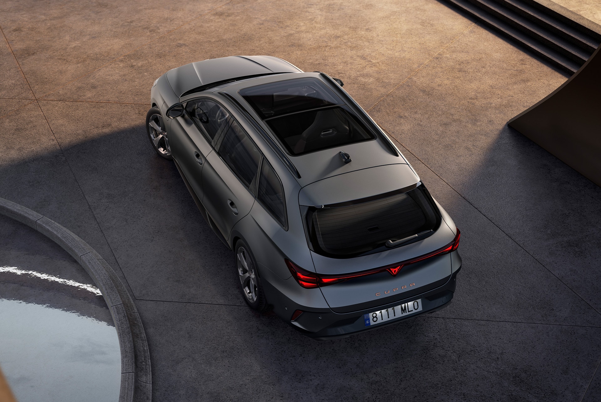 This image features a bird’s-eye rear view of the CUPRA Leon Sportstourer in sleek matte grey. Its sporty and refined design is accentuated by the natural light, showcasing its modern and dynamic styling. This image features a bird’s-eye rear view of the CUPRA Leon Sportstourer in sleek matte grey. Its sporty and refined design is accentuated by the natural light, showcasing its modern and dynamic styling.