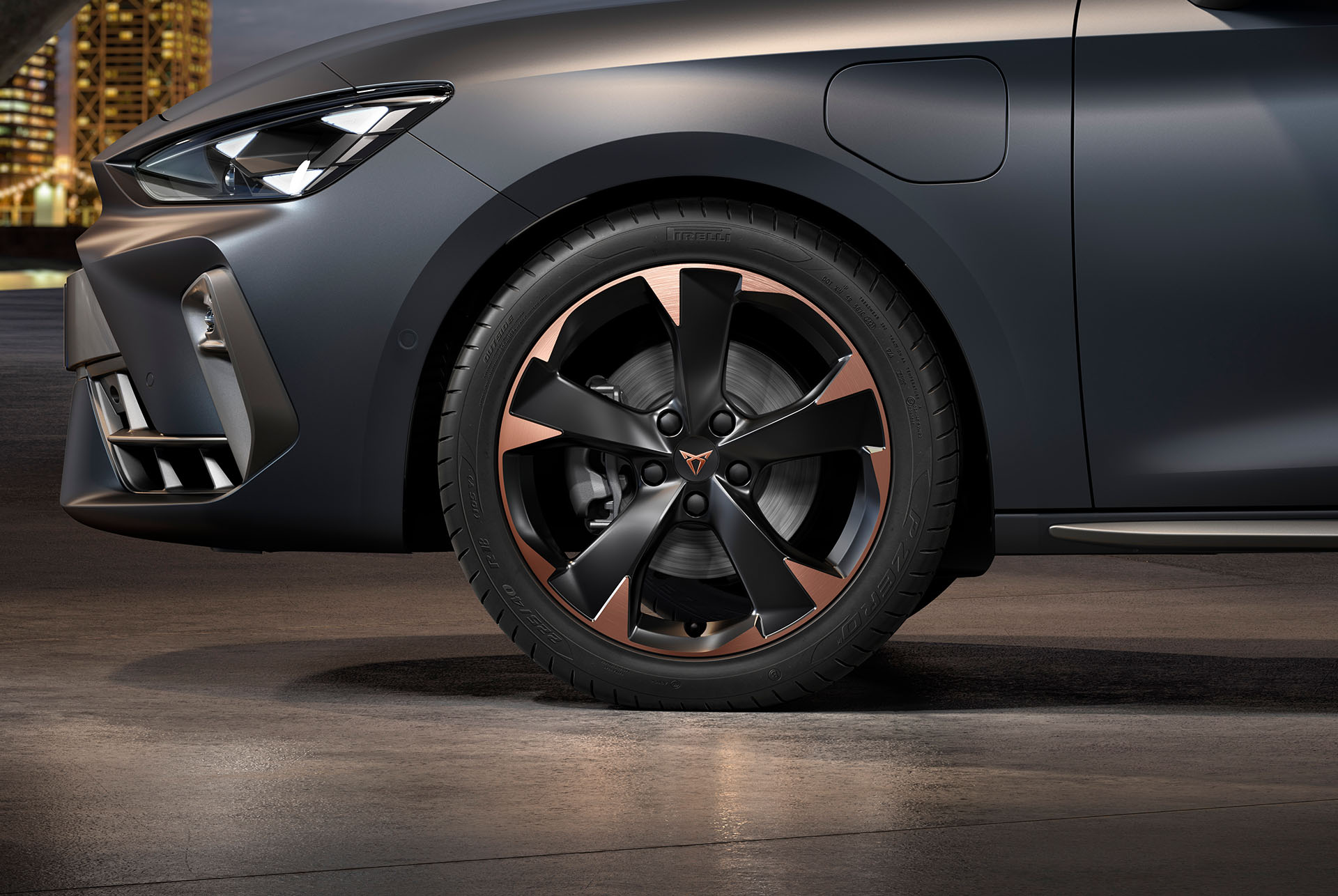 front side view of left mistral garbi copper machined alloy wheels for the new cupra leon sportstourer 2024, tyres, signature headlights and matt grey body