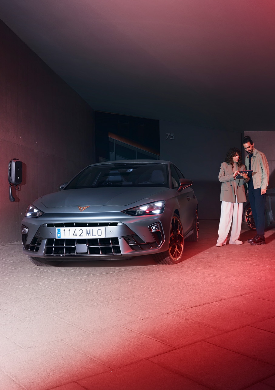 three quarter bird’s eye view of the new Cupra Leon 2025 rear, dark setting and mirror reflection of the front.