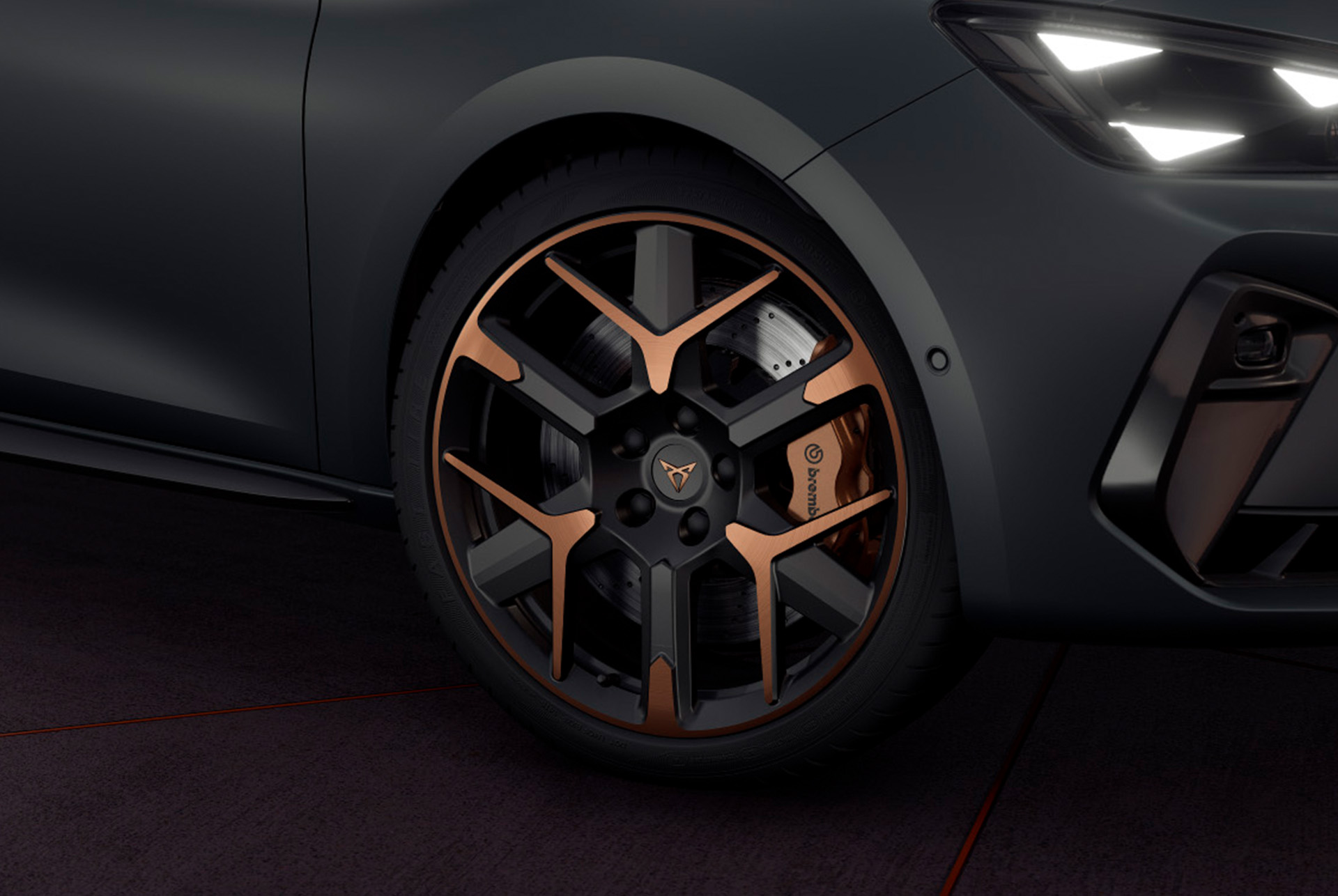 close up of new cupra leon 2024 hailstorm copper accent and black forged wheels with a triangle eye headlight