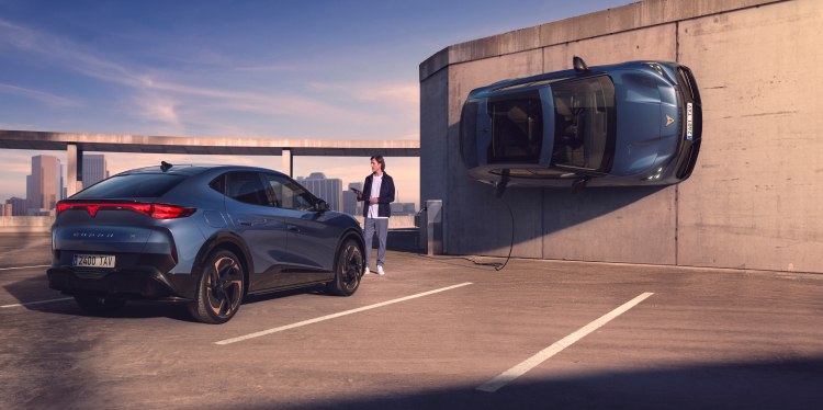 A cupra vehicle displayed in an  urban parking setting, showcasing a vehicle  fleet, the cupra tavascan and auto credit  (pcp), offering tailored finance solutions for  owning or leasing a cupra vehicle.