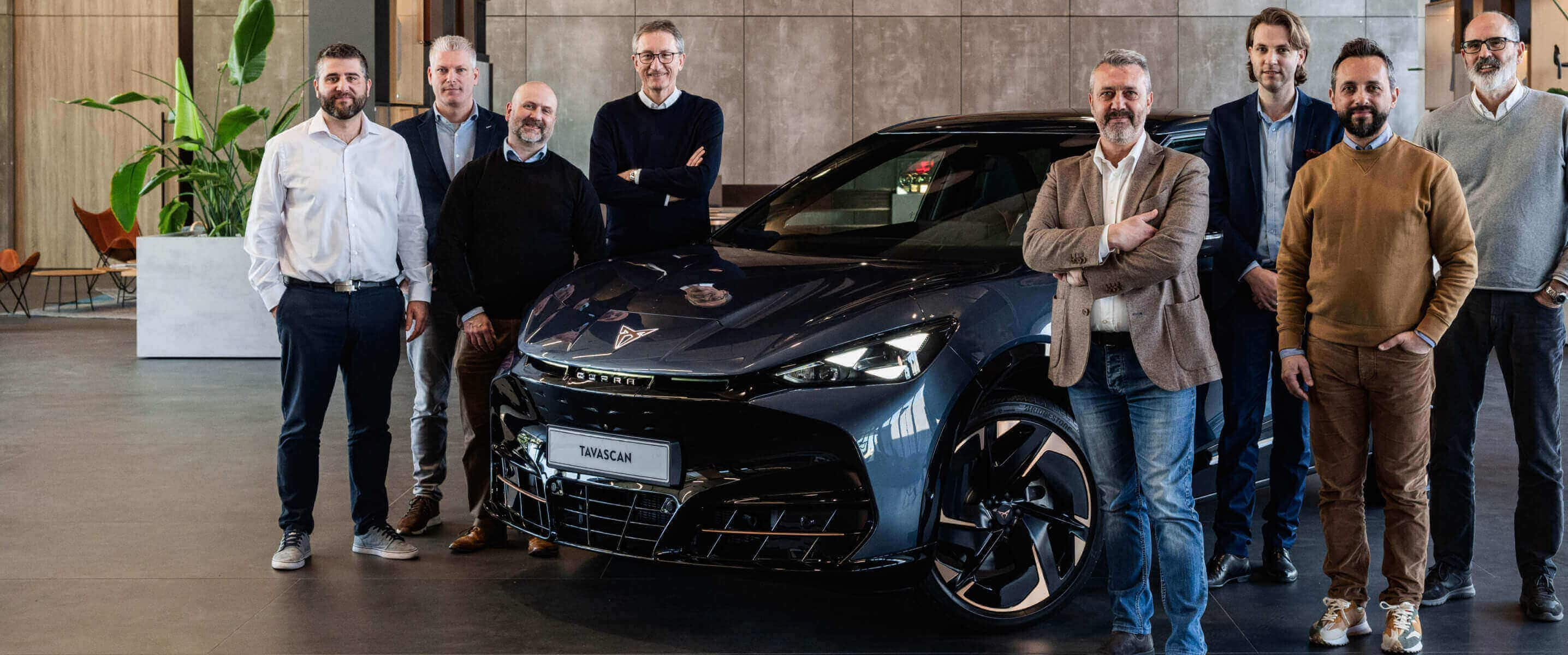 Cupra tavascan vehicle inside as showroom with fleet managers, copper cupra logo on the wall.