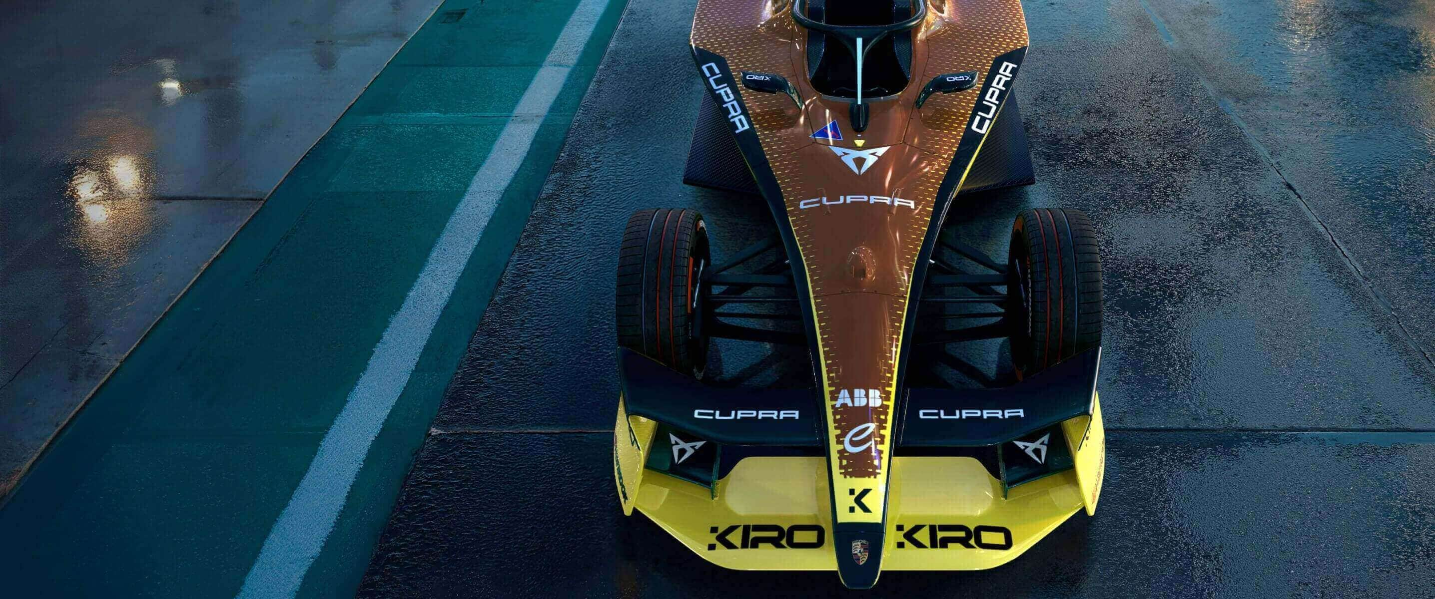 Front view of the cupra kiro formula e car showcasing its copper inspired livery with bold black and yellow accents, designed for the 2025 formula e season, on a wet race track.