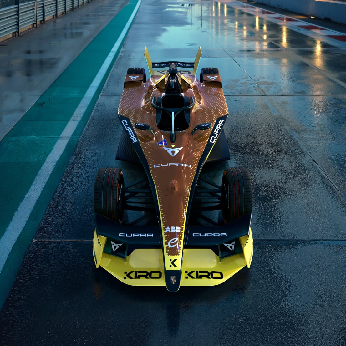 The cupra kiro formula e car with its striking copper and yellow livery, highlighted on a wet race track, designed to reflect the brand's electrification and racing dna.