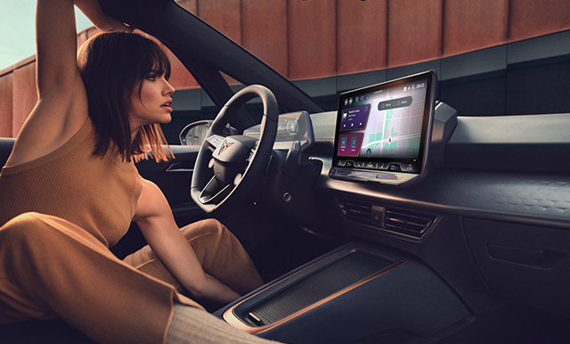Woman viewing the CUPRA OTA updates on her car's infotainment device.